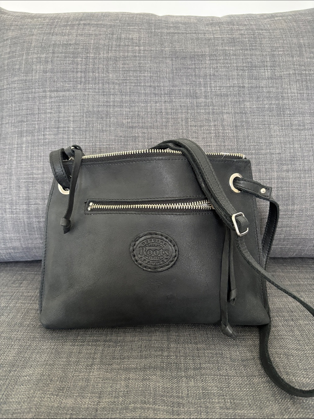 Roots Edie bag Cervino Black Crossbody with Front Zip and Embossed Logo